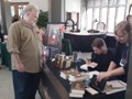 Signing a book for Rev. Seli - at Jubilee Artcraft, Jubilee United Church, Toronto, Ontario